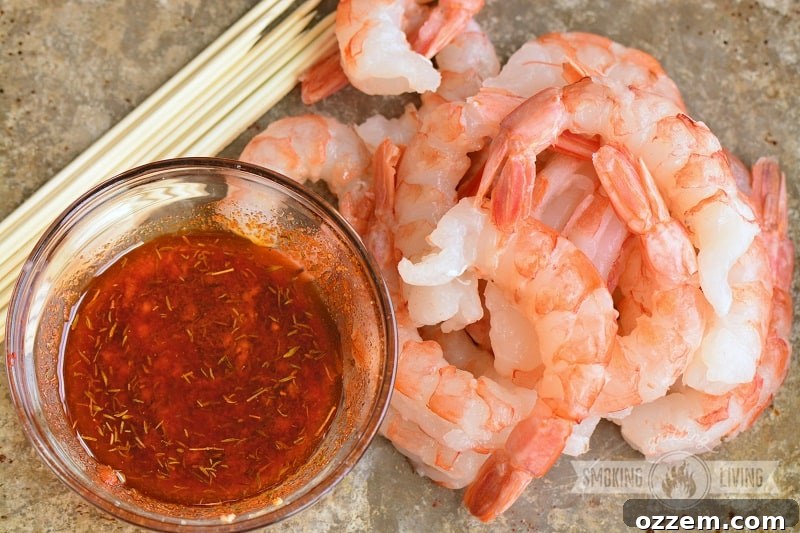 shrimp being coated with wet rub in a bowl