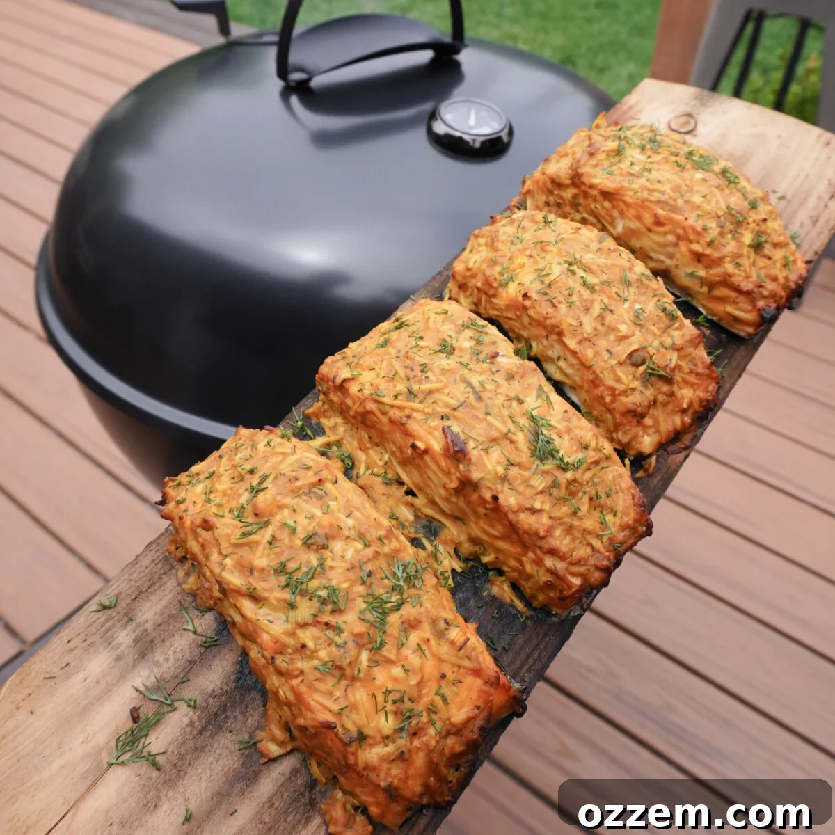 Grilled Salmon with Dill Mustard Sauce plated on a cedar plank.