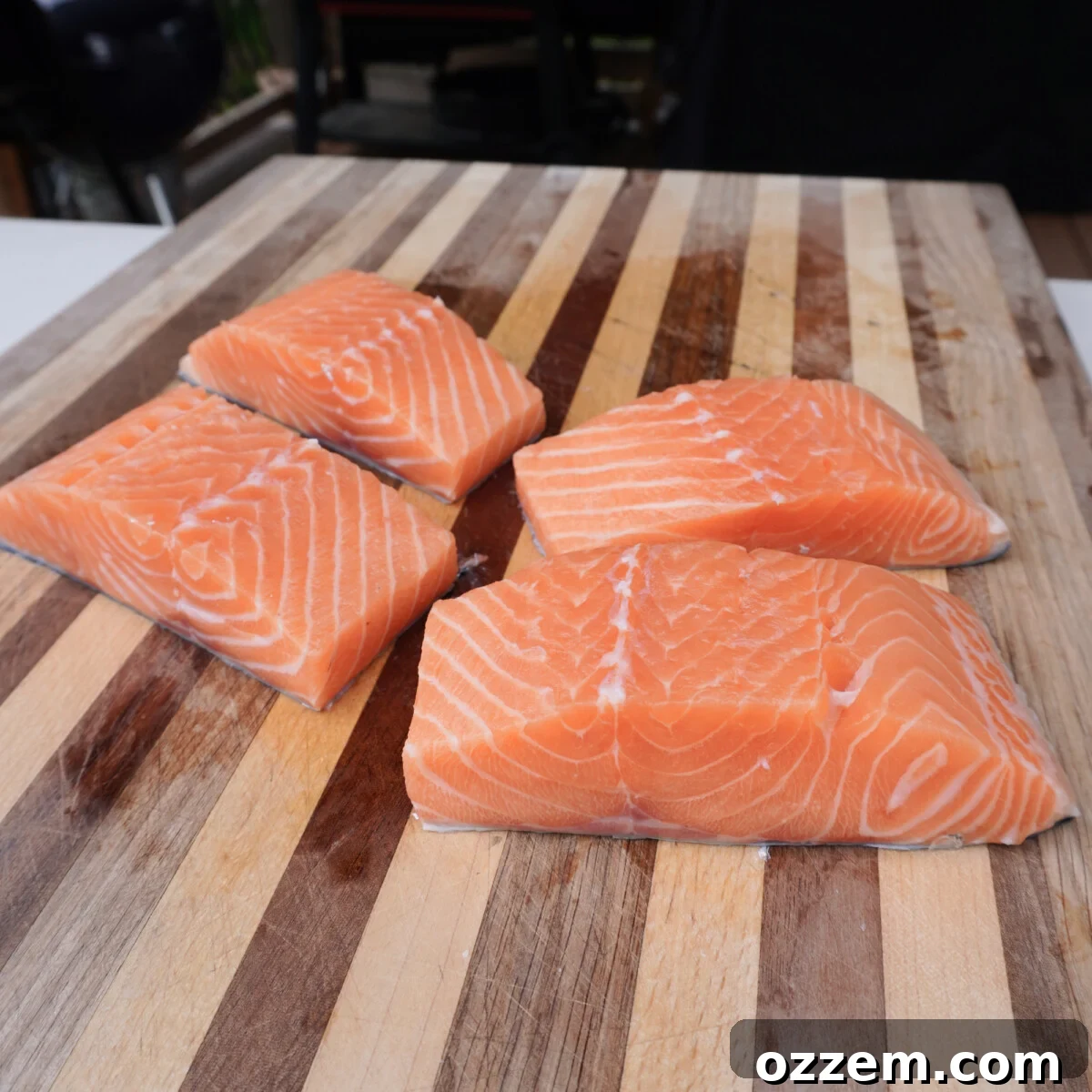 Evenly sliced salmon strips ready for sauce application.