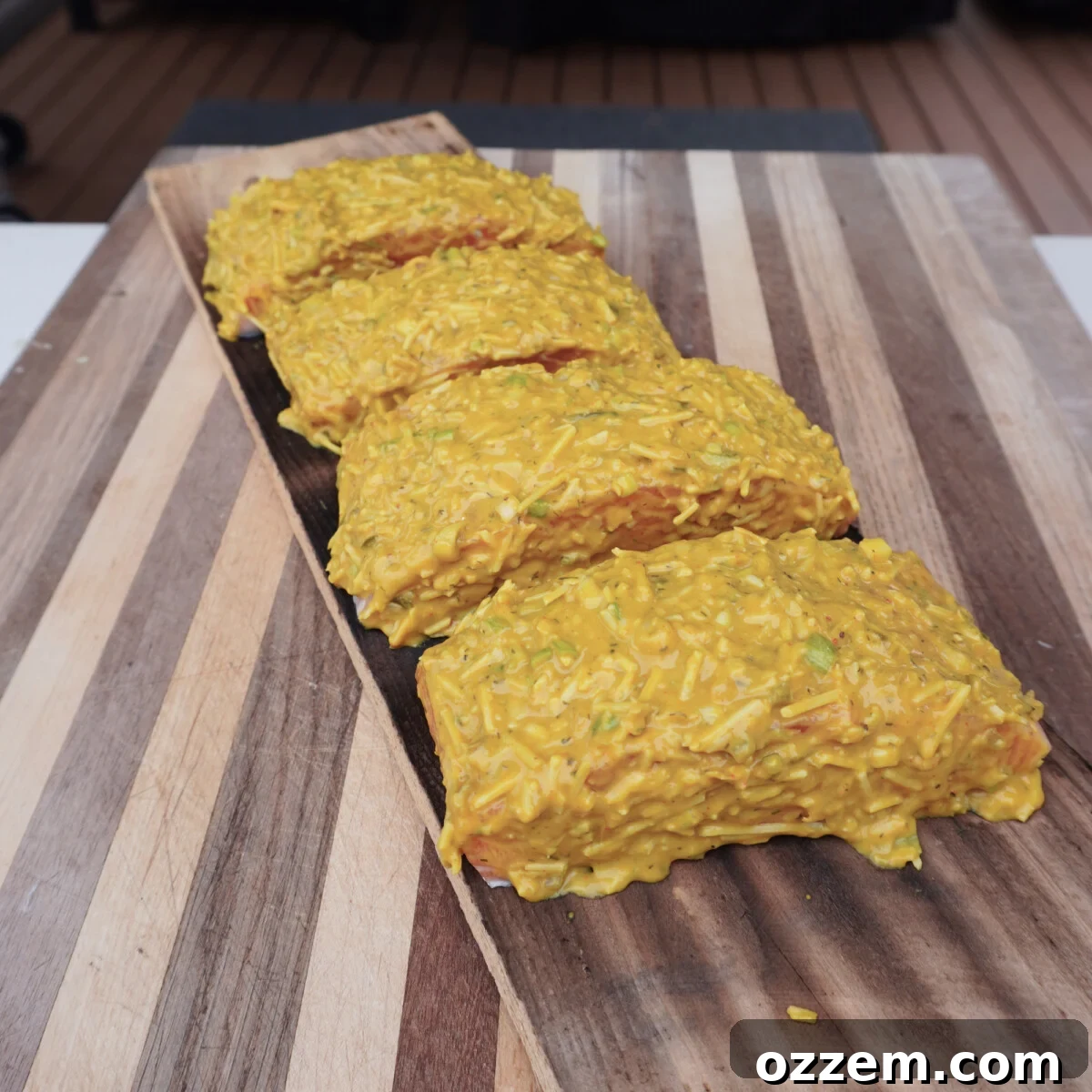 Raw salmon pieces generously coated with dill mustard sauce.