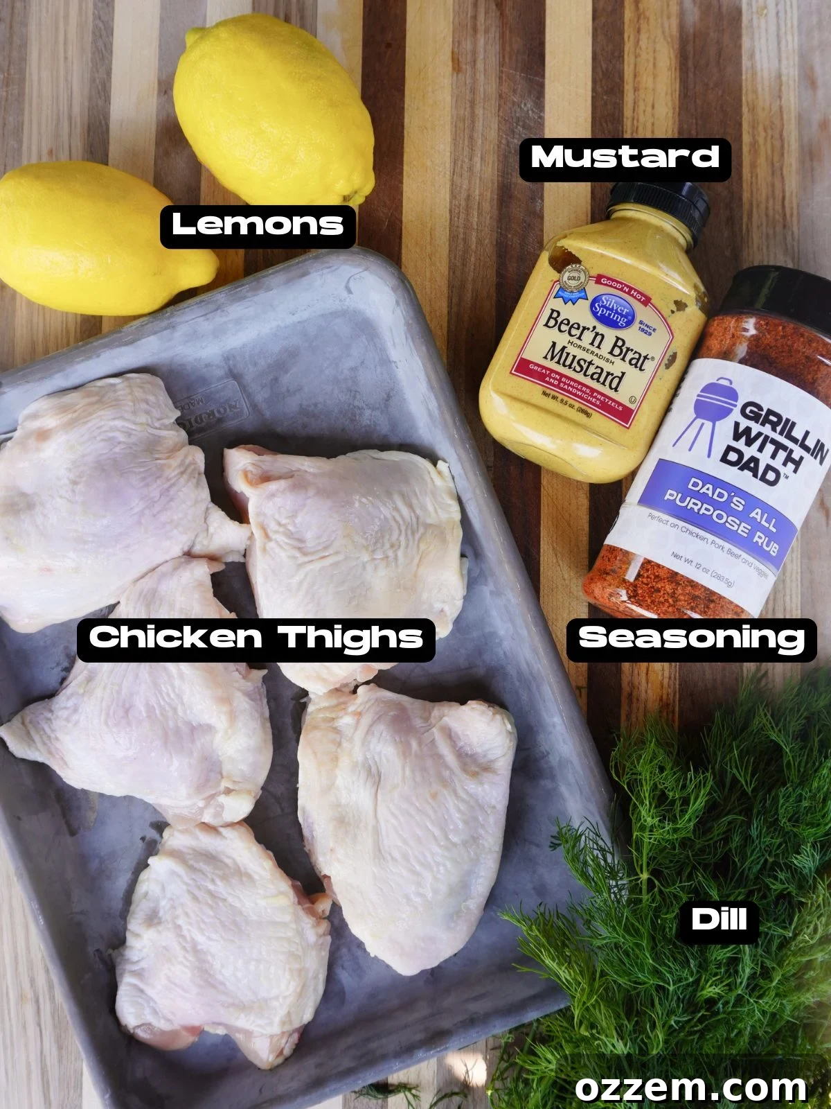 A selection of fresh ingredients including chicken thighs, lemons, dill, sour cream, and spices for grilled lemon dill chicken thighs.