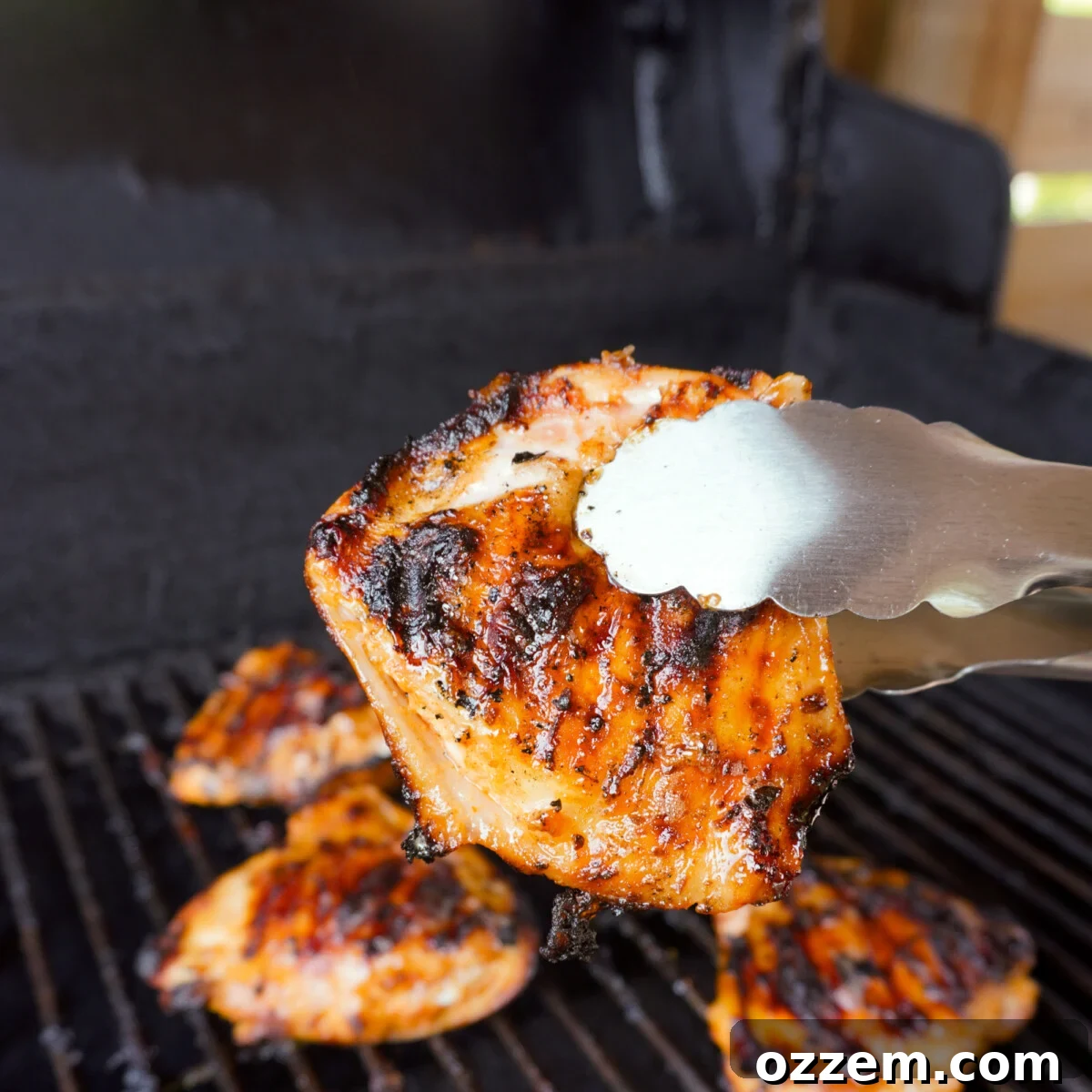 Plated grilled lemon dill chicken thighs garnished with fresh dill and a side of creamy dill dip, ready to be enjoyed.