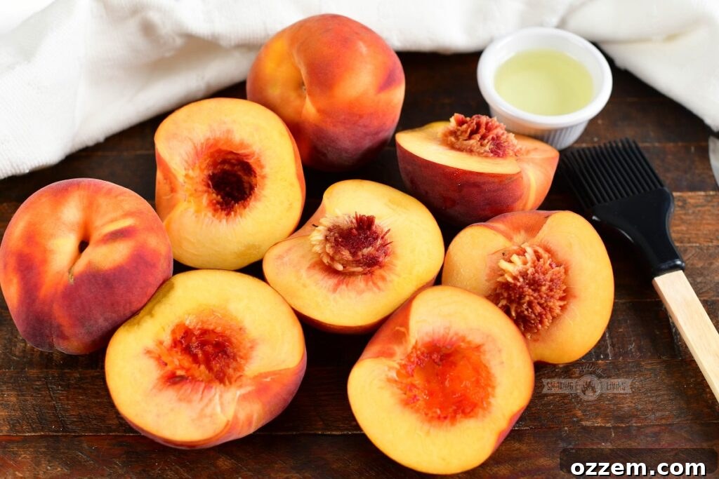 peaches cut in half with a brush and small cup of oil