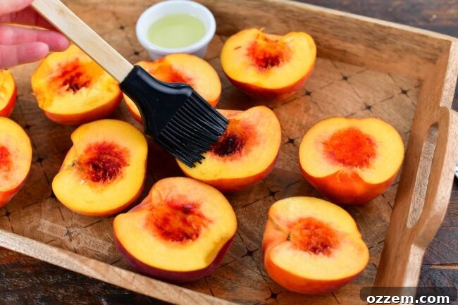 brushing oil with a silicone brush on halves of peaches
