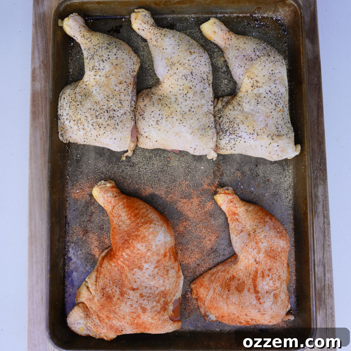 Sweet tea brined chicken quarters, patted dry and seasoned, ready for smoking.