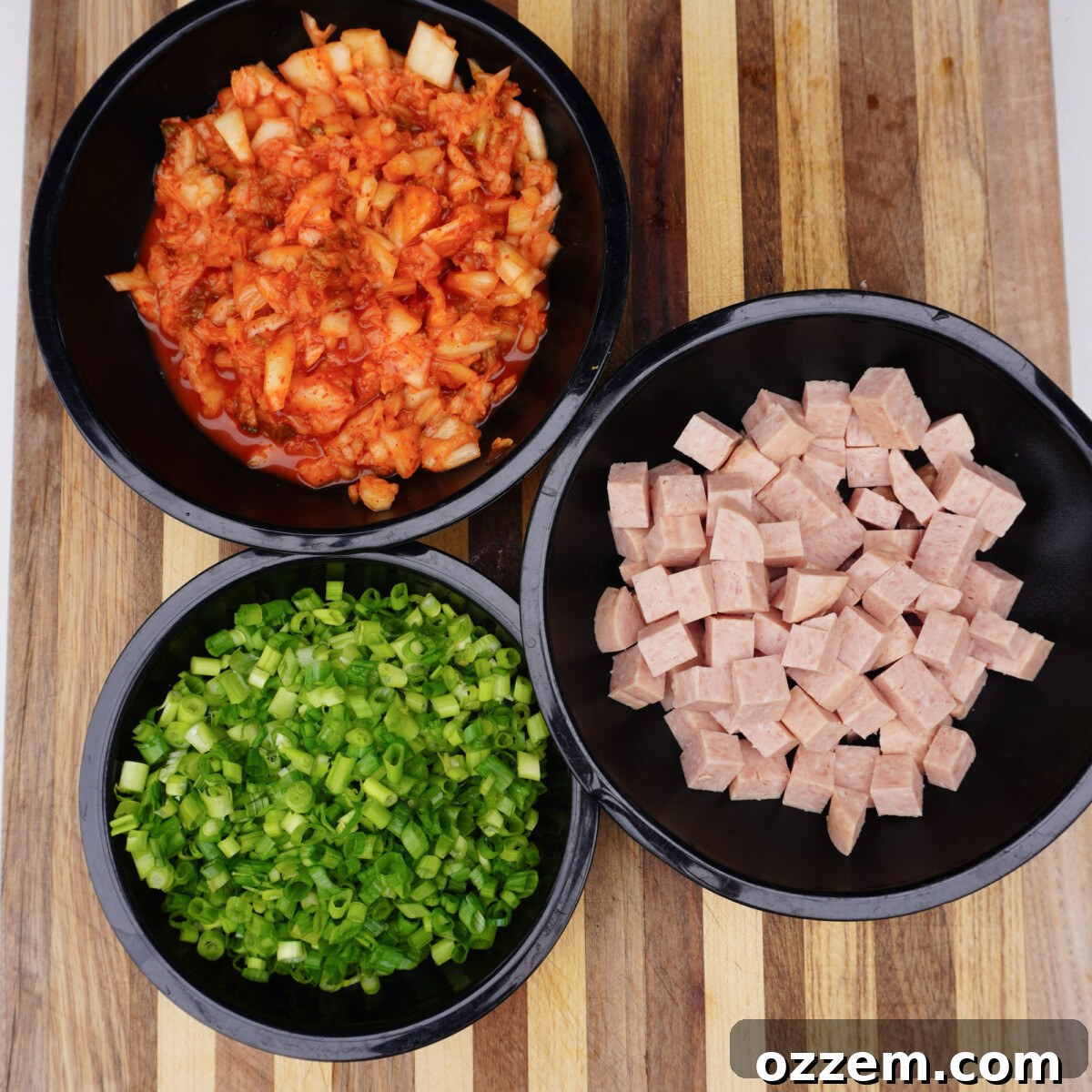 All ingredients for kimchi fried rice meticulously prepared and separated in bowls.