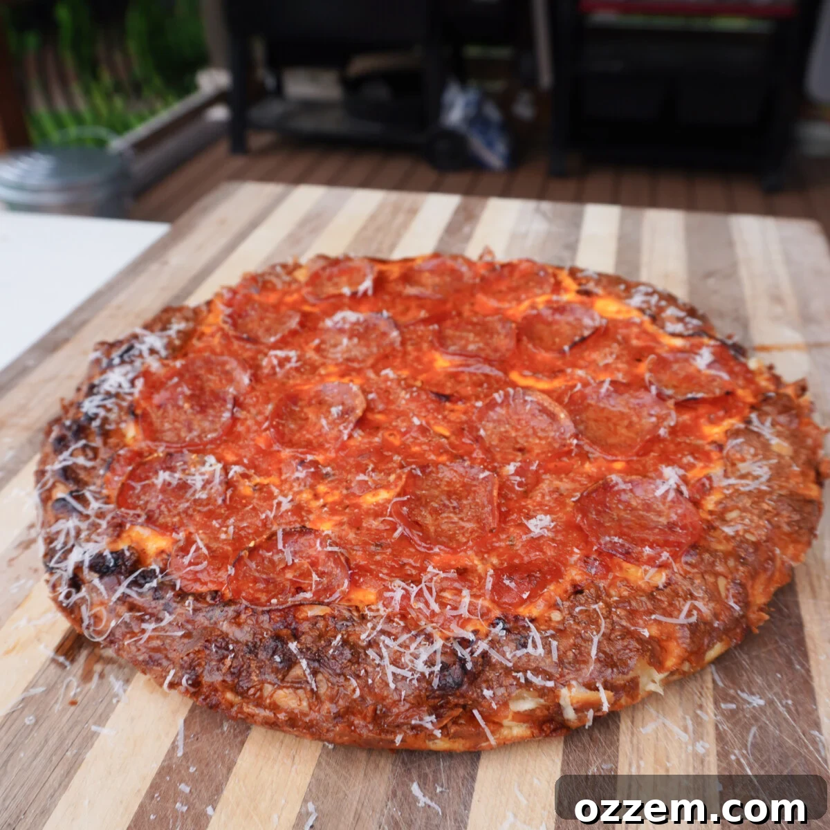 Delicious easy cast iron pizza cooling on a wooden cutting board, ready to be sliced.