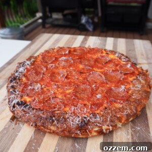 An easy cast iron pizza on a cutting board, garnished and ready to be served.