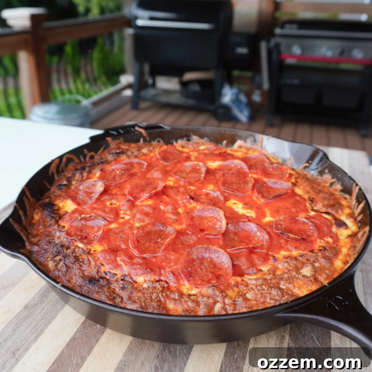 A homemade pepperoni pizza freshly removed from the oven, cooling off on a wire rack.
