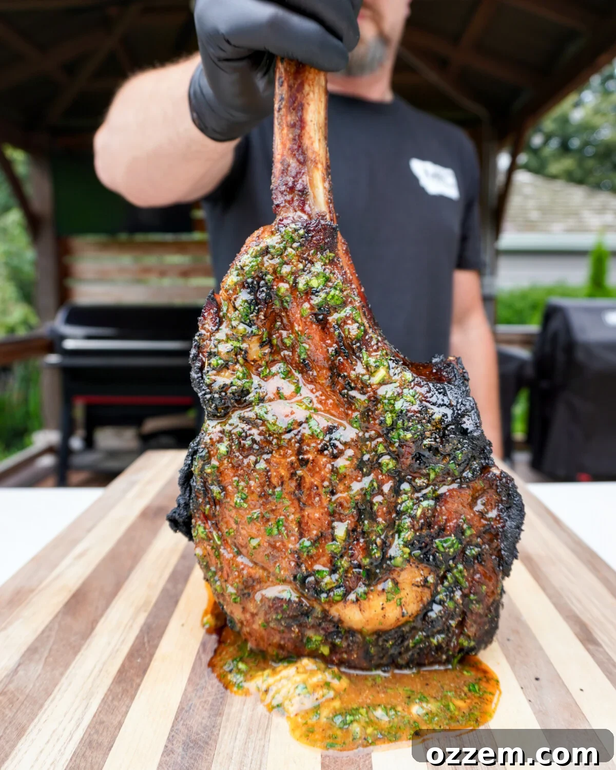 Sizzling Tomahawk with Zesty Cajun Butter 2 perfectly grilled tomahawk steak with glistening cajun honey butter on top, ready to be sliced.