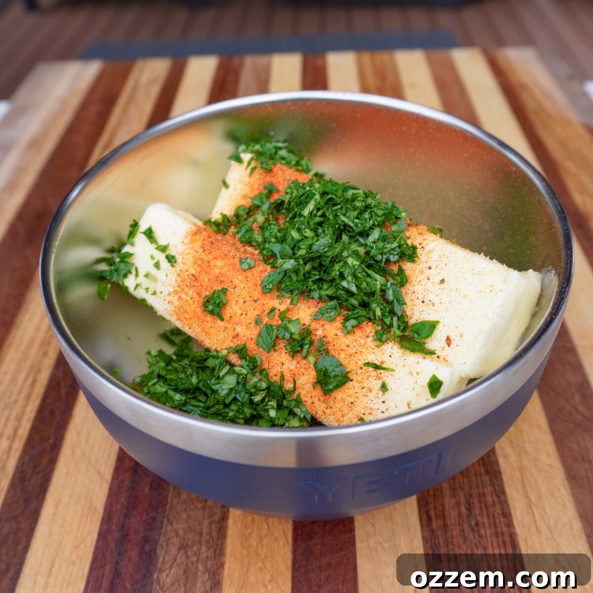 Sizzling Tomahawk with Zesty Cajun Butter 8 Raw ingredients for Cajun honey compound butter in a bowl: butter, chopped parsley, and seasoning.