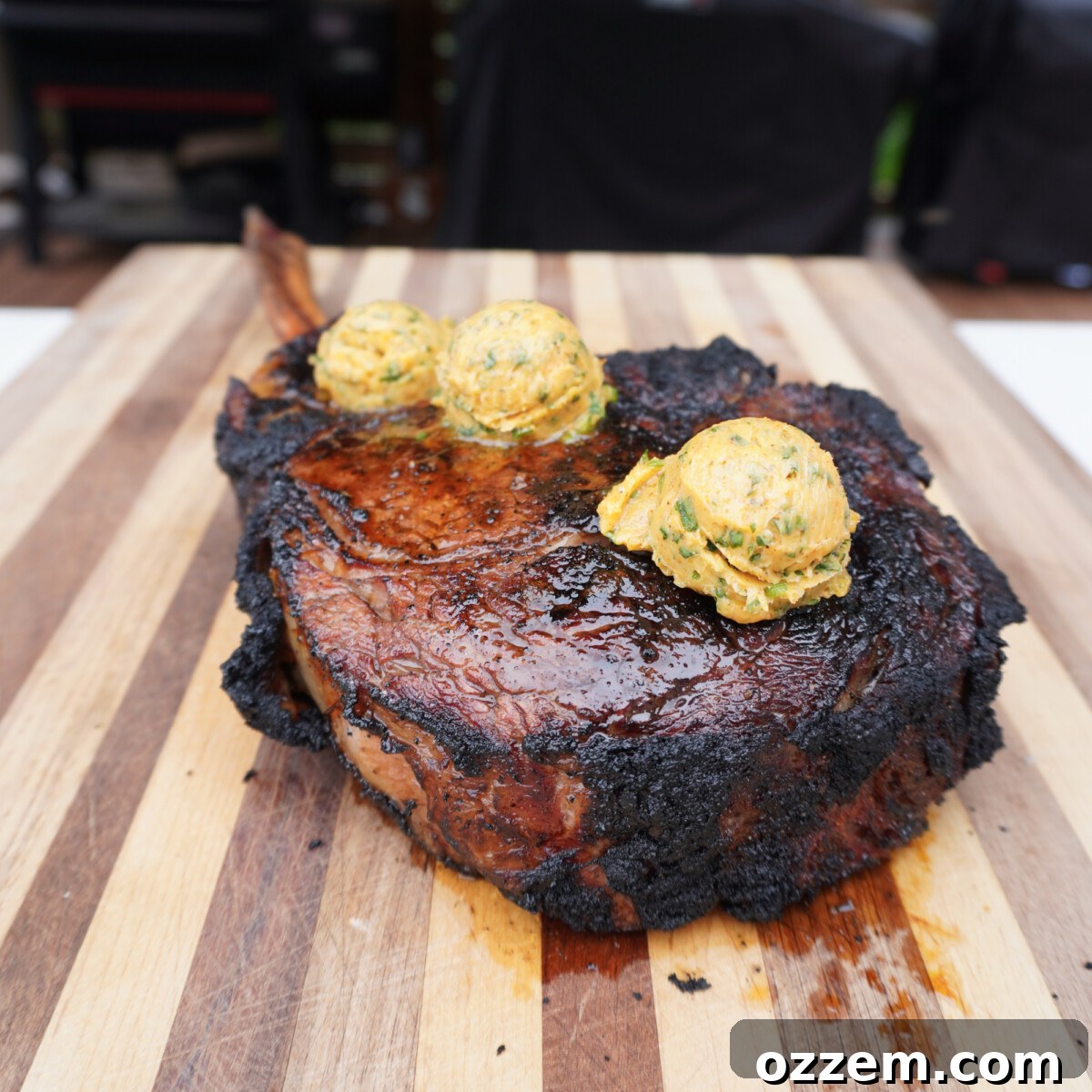 Sizzling Tomahawk with Zesty Cajun Butter 10 A perfectly cooked grilled tomahawk steak adorned with melting cajun butter, ready for serving.