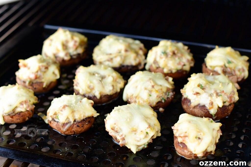 Finished smoked stuffed mushrooms cooling on the smoker grate after cooking.
