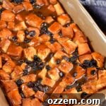 top view of bread pudding with sauce in a baking dish
