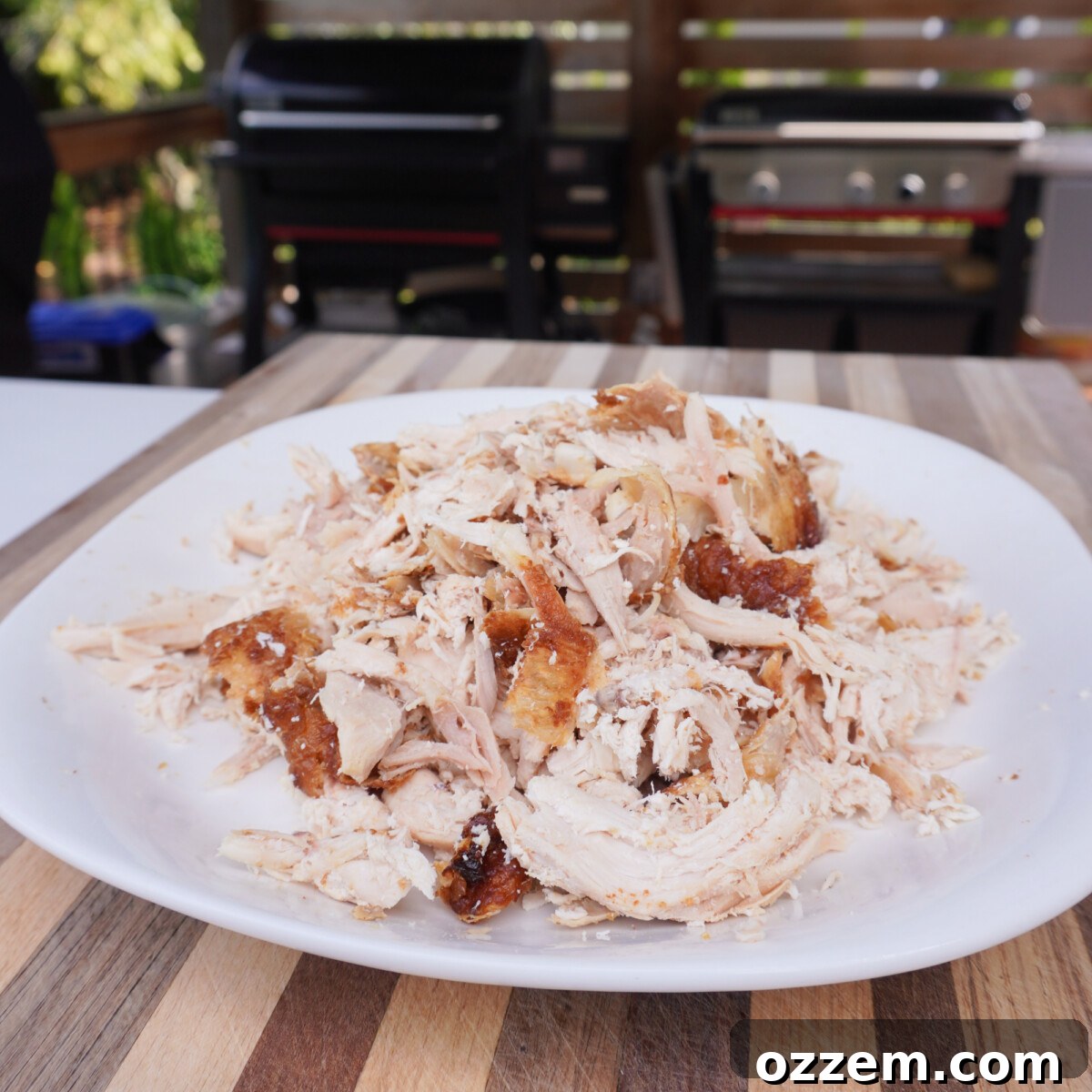 A close-up shot of perfectly shredded cooked chicken, showcasing its tender texture, ready to be incorporated into the flavorful casserole base. The chicken appears juicy and well-prepared.