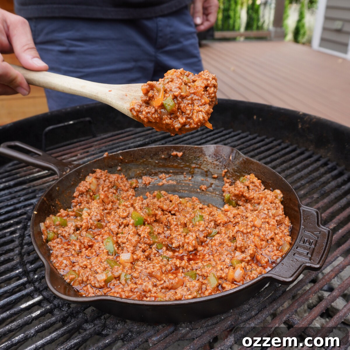 The sloppy joe mixture, fully cooked and simmering in a cast iron skillet.