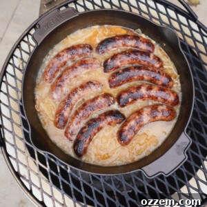 The best grilled beer brats in a Dutch oven over a fire.