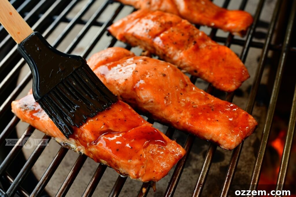Caramelized Maple BBQ Grilled Salmon 7 Two salmon fillets grilling on direct heat with grill marks