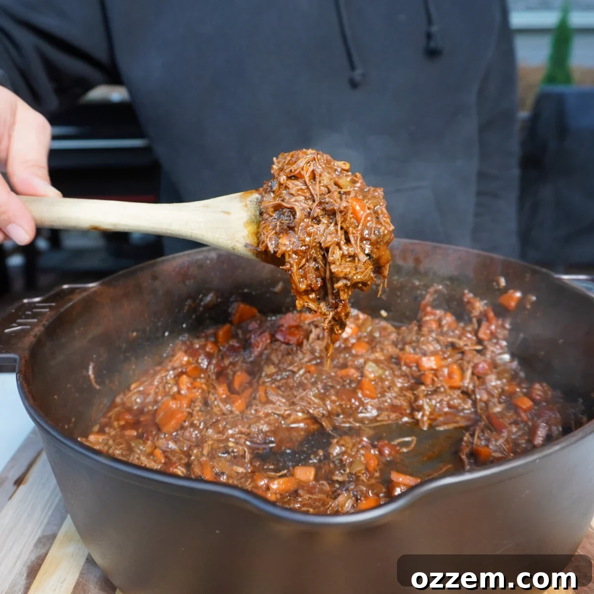 A spoonful of tender grilled short ribs ragu mixture.