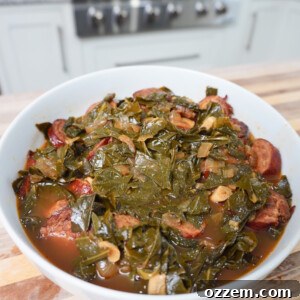 Collard Greens and Sausage plated in a white bowl.