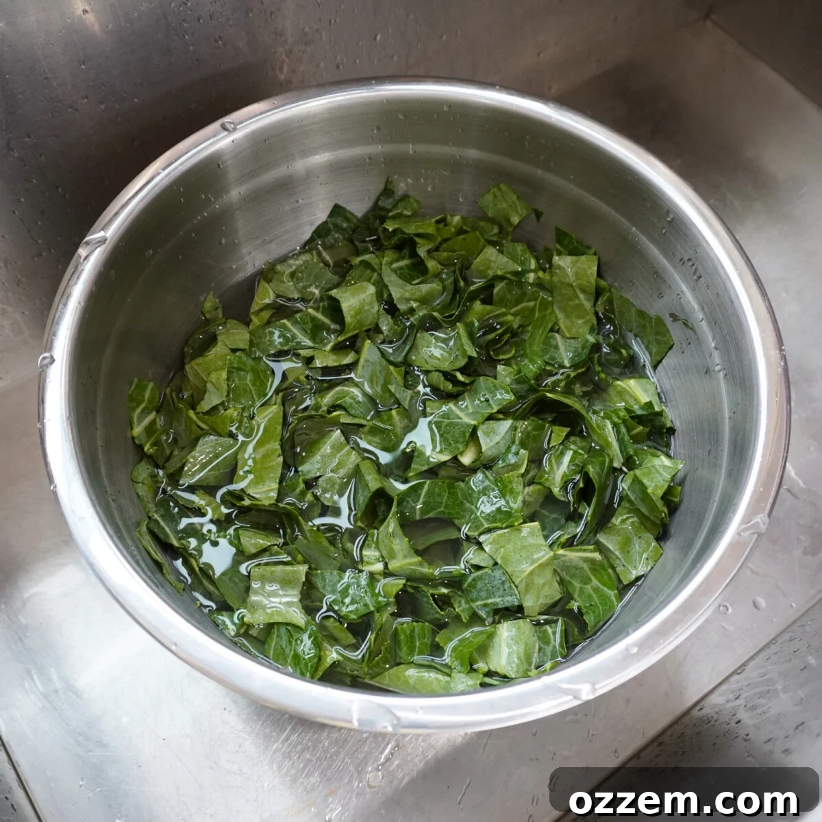 cleaned collard greens in a bowl with water.