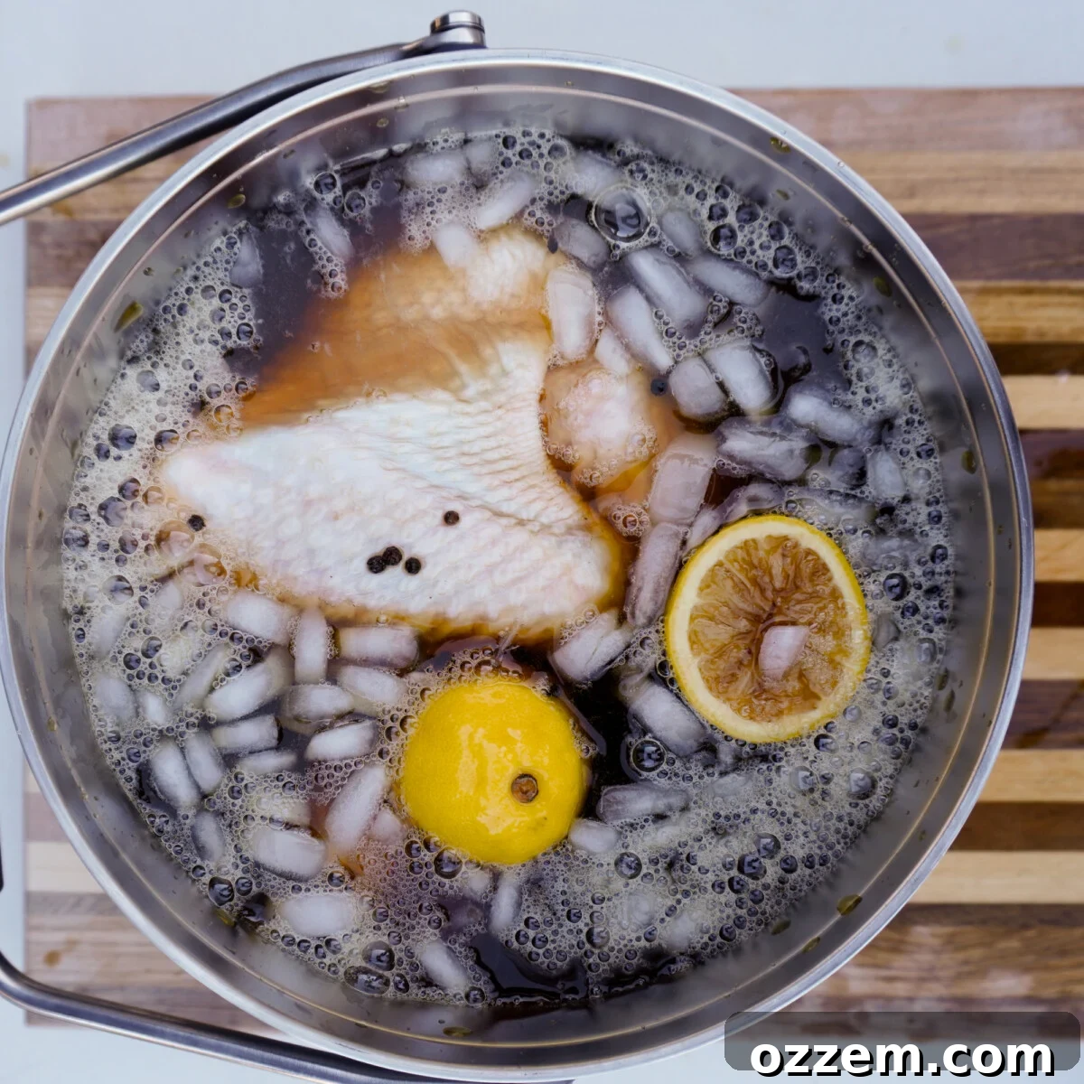 Sweet tea brine with melting ice, showing the cooling process before adding the turkey.