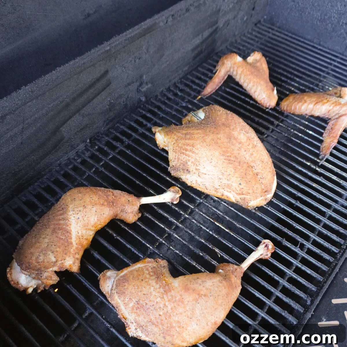 Sweet tea brined grilled turkey pieces cooking on the grill over indirect heat.