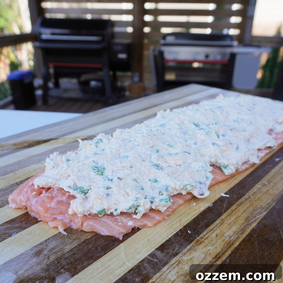 Salmon fillet with creamy cheese filling spread on top.