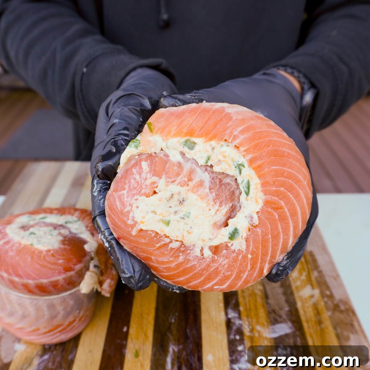 Rolled up salmon fillet, secured with twine, ready for slicing.