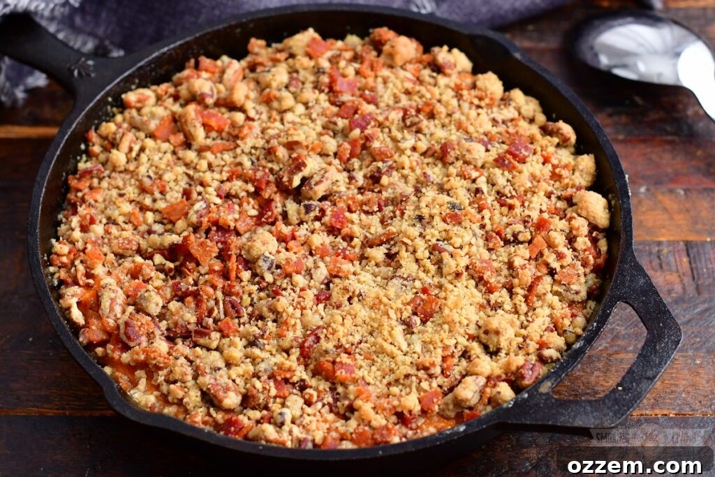 Rich and golden smoked sweet potato casserole, perfectly baked in a rustic cast iron skillet, ready to be served.