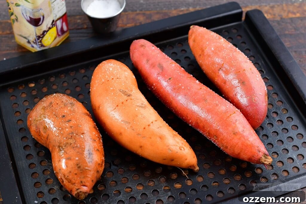 Sweet potatoes being prepared for smoking, showing a rustic cutting board and fresh potatoes.