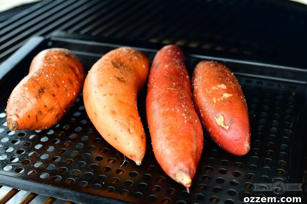 Poking holes into sweet potatoes before smoking to allow smoke penetration and even cooking.