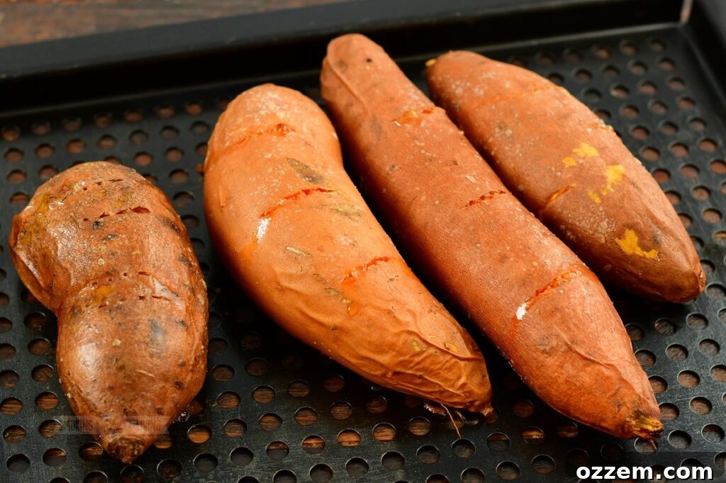 Sweet potatoes seasoned and ready to be placed on the smoker grate for a smoky flavor infusion.