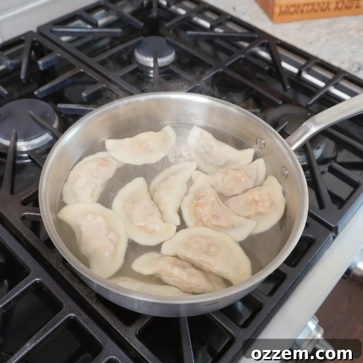 BBQ Pulled Pork Pierogi 12 Pulled pork pierogi boiling in a pot of water.