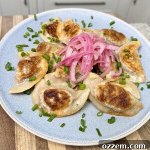 BBQ Pulled Pork Pierogi 15 Pulled pork pierogi placed with pickled red onion on top.