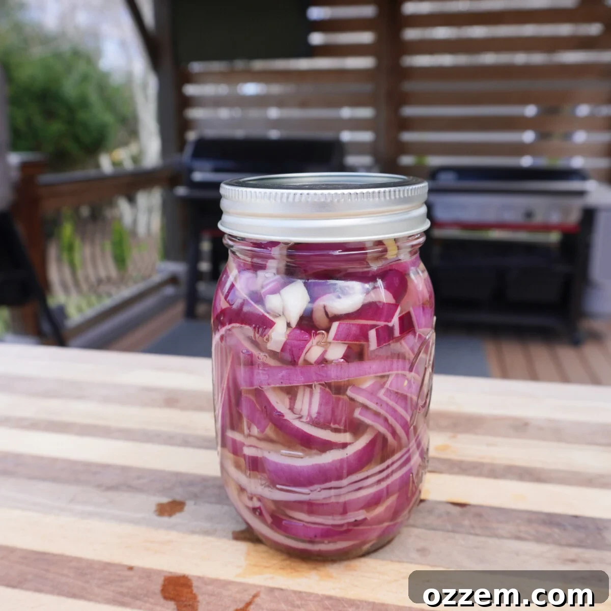 BBQ Pulled Pork Pierogi 5 Pickled red onion slices in a clear mason jar.
