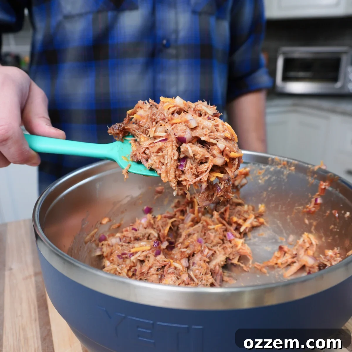 BBQ Pulled Pork Pierogi 9 A bowl filled with a mixture of pulled pork, diced red onion, shredded cheese, and BBQ sauce.