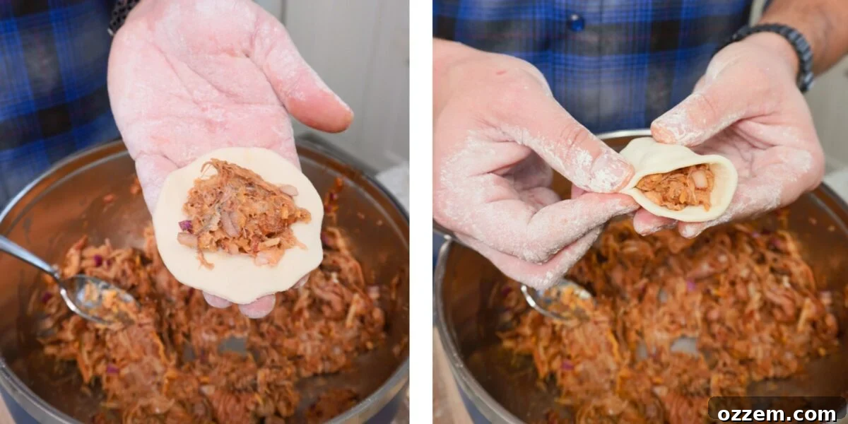 BBQ Pulled Pork Pierogi 10 A close-up of hands filling a pierogi dough circle with pulled pork mixture and starting to seal it.
