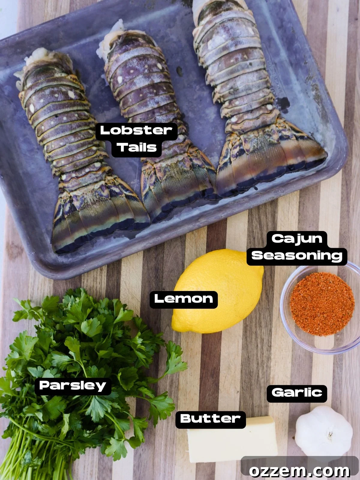Fresh ingredients for smoked Cajun lobster tail including lobster, butter, garlic, and spices.