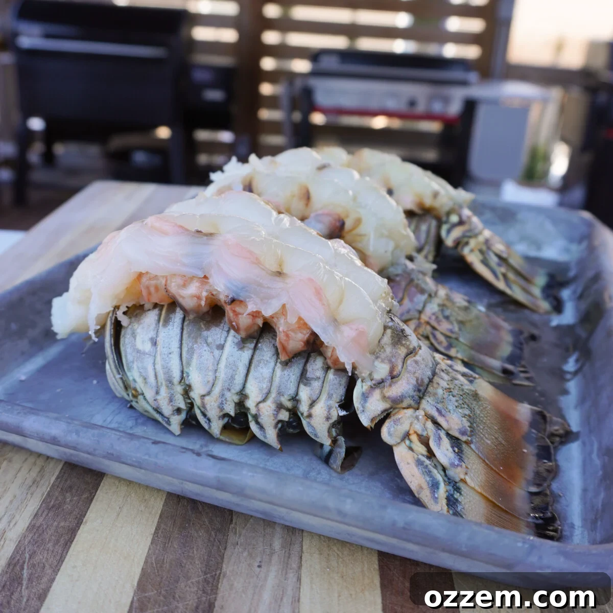 Raw exposed lobster tail meat, butterflied for smoking.