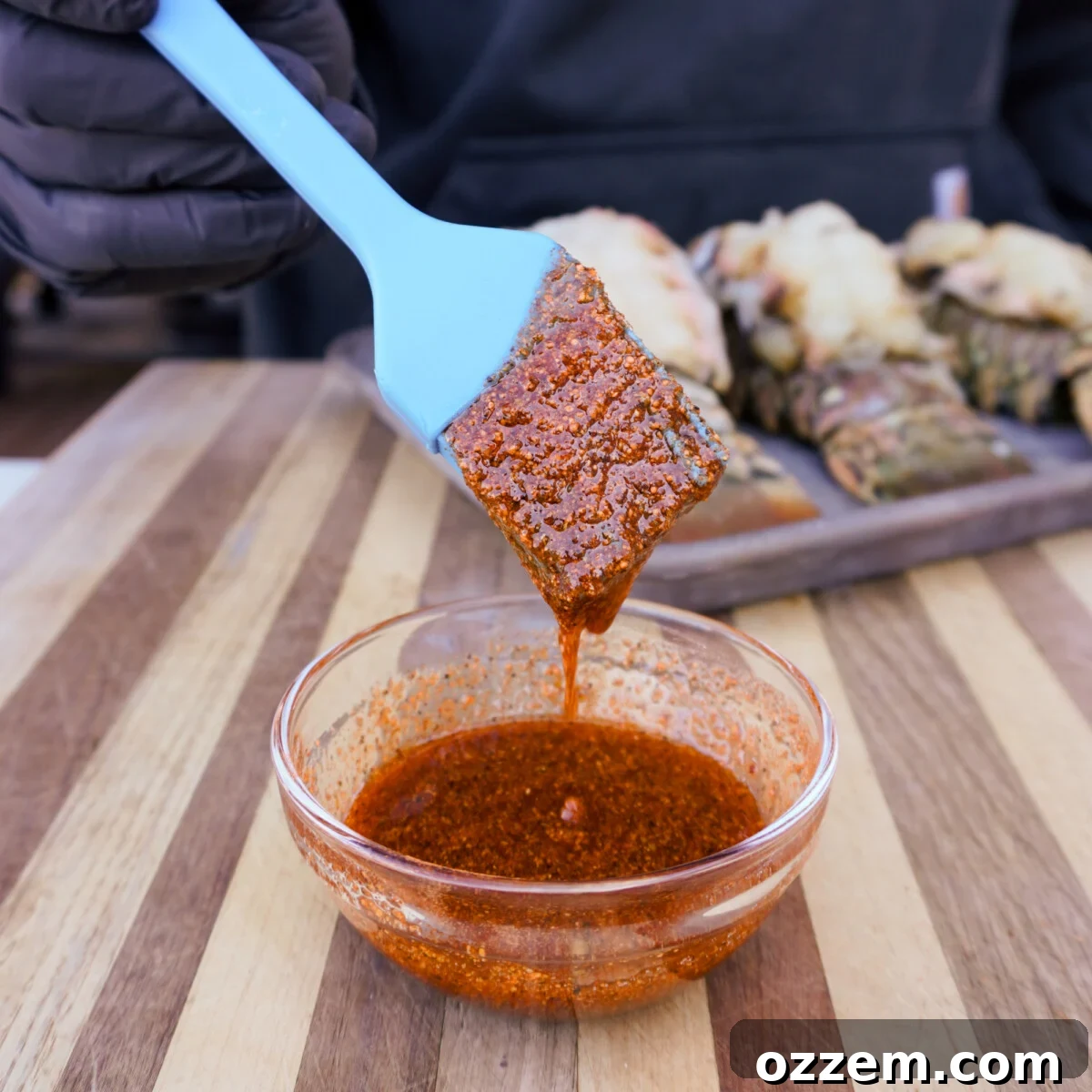 Cajun honey seasoning and olive oil mixture being prepared for lobster.
