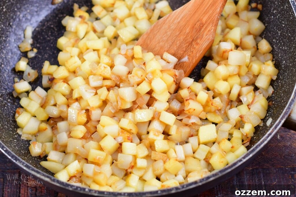 cooked diced onions, apple, and pear in a pan
