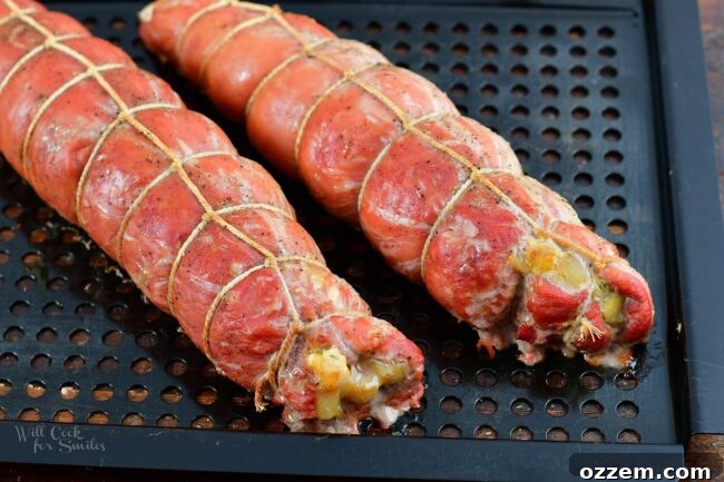 smoked pork tendelroins wrapped with twine on the metal basket