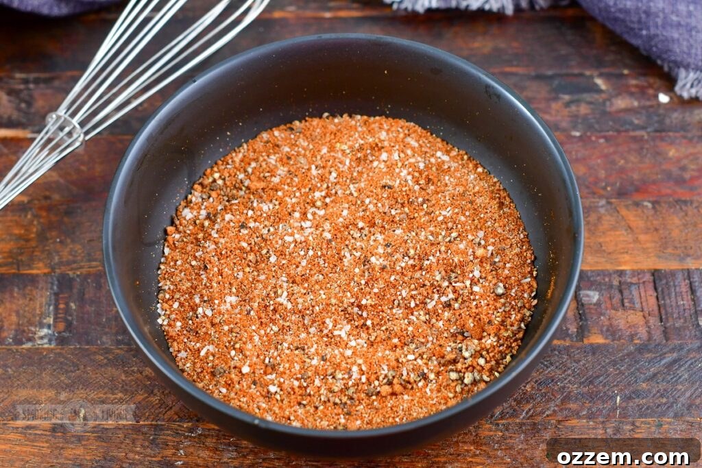 mixed spices for dry rub in a black bowl, ready to be combined
