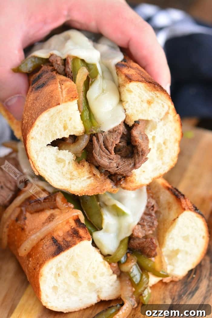 holding philly cheesesteak sandwich