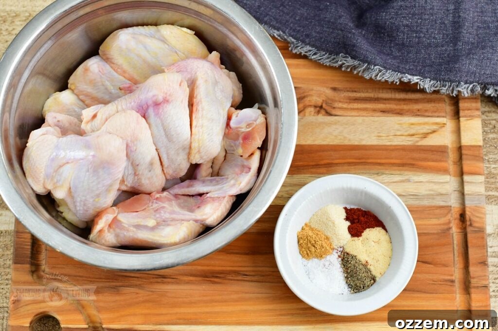chicken wings in a bowl and seasoning next to it