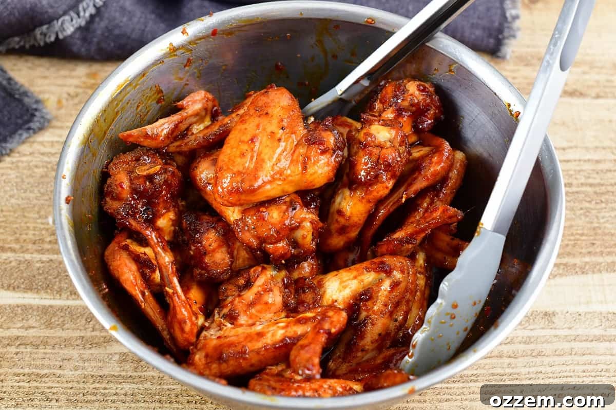 tossing the smoked wings with the glaze