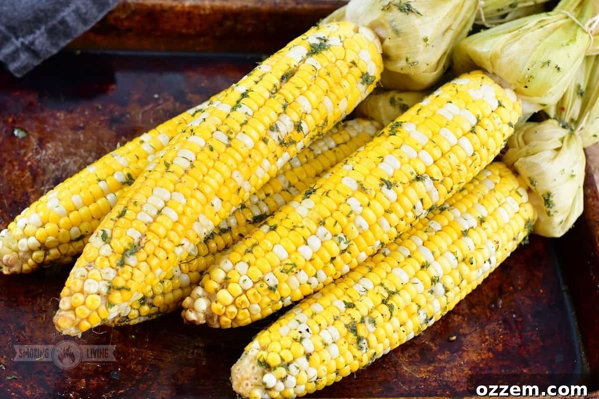 Close-up of freshly smoked corn on the cob on a pan, ready to serve