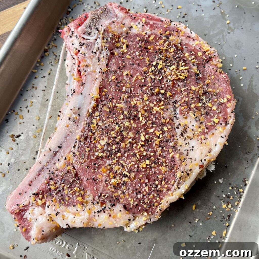 Flame-Kissed Bone-in Ribeye 3 Bone-in ribeye steak seasoned with Montreal Steak Seasoning, ready for the grill.