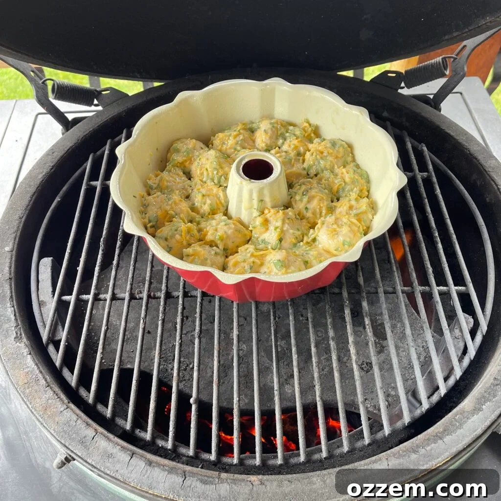 Garlic and Herb Monkey Bread cooking in a bundt pan on a grill.